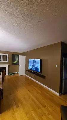 a living room with a flat screen tv on a wall at YK Aurora in Yellowknife
