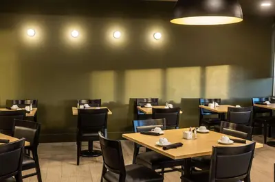 a dining room with tables and chairs in a restaurant at DoubleTree by Hilton Calgary North in Calgary