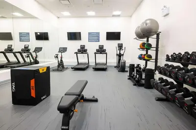 a gym with several rows of exercise bikes and weights at DoubleTree by Hilton Calgary North in Calgary