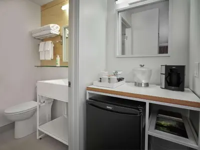a bathroom with a sink and a toilet and a mirror at Coast Canmore Hotel & Conference Centre in Canmore