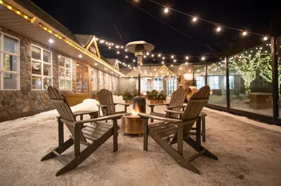 a patio with chairs and a table and lights at Coast Canmore Hotel & Conference Centre in Canmore