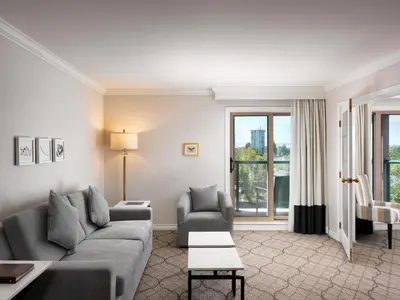 a living room with a couch and a table at Hotel Grand Pacific in Victoria