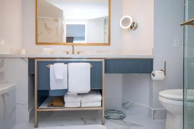 a bathroom with a sink and a toilet at The Sutton Place Hotel Vancouver in Vancouver
