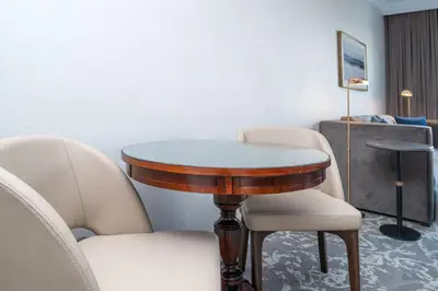 a table and chairs in a room with a table at The Sutton Place Hotel Vancouver in Vancouver
