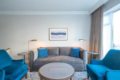 a living room with a couch and two chairs at The Sutton Place Hotel Vancouver in Vancouver