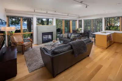 a living room with a couch and a fireplace at Brentwood Bay Resort & Spa in Brentwood Bay