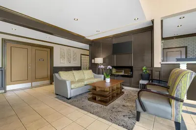 a living room with a couch and a table at Best Western King George Inn & Suites in Surrey