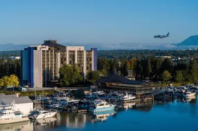 a group of boats docked at a marina with a plane at Radisson Blu Vancouver Airport Hotel & Marina in Richmond