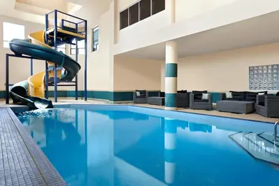 a swimming pool with a slide in a hotel at Four Points by Sheraton Hotel & Suites Calgary West in Calgary