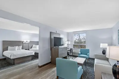 a hotel room with a bed and a tv at Emerald Hotel & Suites Calgary Airport in Calgary