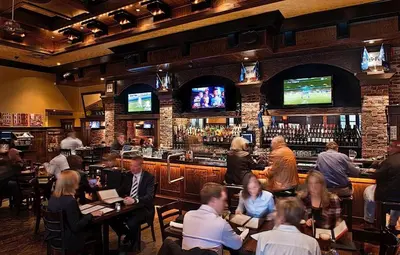 a group of people sitting at a bar at The St. Regis Hotel in Vancouver