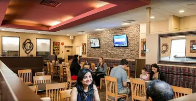 a group of people sitting in a restaurant at Travelodge by Wyndham Edmonton West in Edmonton