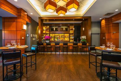 a bar in a restaurant with bar stools at Grand Park Hotel Vancouver Airport, an Ascend Collection Hotel in Richmond