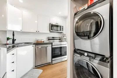 a kitchen with a washer and dryer at Best Location Downtown Chic Suites in Vancouver