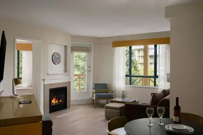 a living room with a fireplace and a couch at Delta Hotels by Marriott Whistler Village Suites in Whistler
