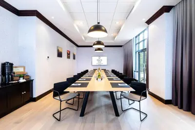 a conference room with a long table and chairs at Delta Hotels by Marriott Whistler Village Suites in Whistler