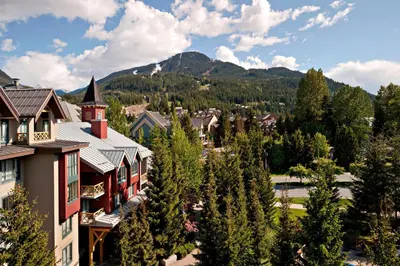 a view of a resort with mountains in the background at Delta Hotels by Marriott Whistler Village Suites in Whistler