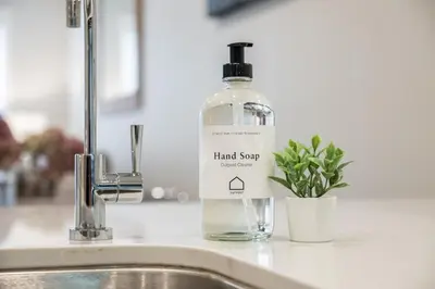a bottle of hand soap sitting on a sink at The Aspens by Outpost Whistler in Whistler