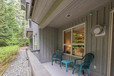 a porch with two chairs and a table at The Aspens by Outpost Whistler in Whistler