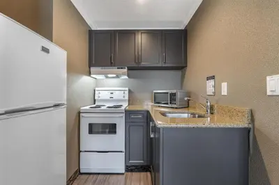 a small kitchen with a sink and a stove at BEST WESTERN PLUS Carlton Plaza Hotel in Victoria