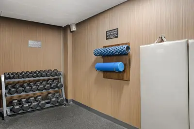 a gym with a bunch of dumbbells on the wall at BEST WESTERN PLUS Carlton Plaza Hotel in Victoria