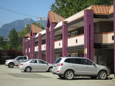 a group of cars parked in front of a building at North Vancouver Hotel in North Vancouver