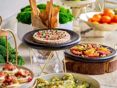 a display of food on a table with plates of food at Fairmont Waterfront in Vancouver