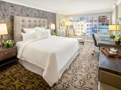 a large white bed in a hotel room at Fairmont Waterfront in Vancouver