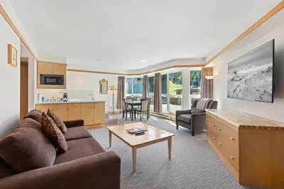 a living room with a couch and a table at Le Chamois by Whistler Premier in Whistler