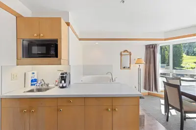a kitchen with a sink and a microwave at Le Chamois by Whistler Premier in Whistler