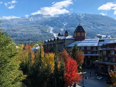 a town in the mountains with trees and buildings at Pinnacle Hotel Whistler in Whistler