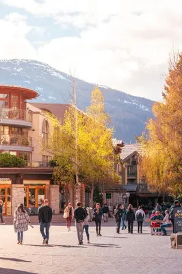 a group of people walking down a city street at Pinnacle Hotel Whistler in Whistler