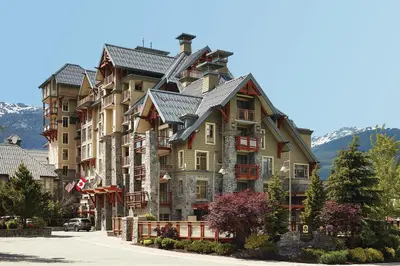 a large apartment building in the mountains at Pan Pacific Whistler Village Centre in Whistler