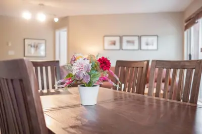 a vase of flowers sitting on top of a table at Deer Lodge by Outpost Whistler in Whistler