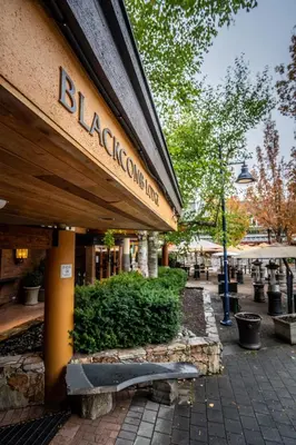a building with a bench in front of a store at Blackcomb Lodge in Whistler