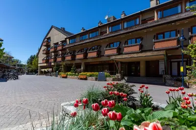 a building with red flowers in front of it at Blackcomb Lodge in Whistler