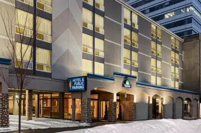 a building with a sign that reads make a hotel manage at Days Inn by Wyndham Edmonton Downtown in Edmonton
