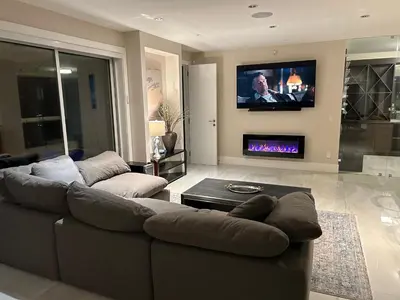 a living room with a couch and a fireplace at Luxury accomodation in West Vancouver in West Vancouver