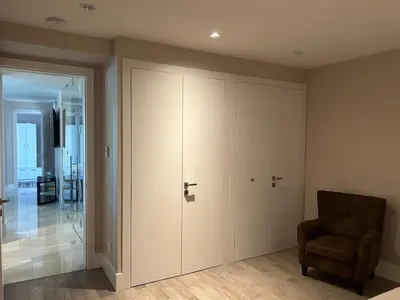a room with a closet and a chair and a door at Luxury accomodation in West Vancouver in West Vancouver