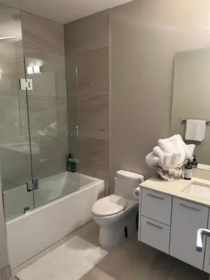 a bathroom with a toilet and a tub and a sink at Luxury accomodation in West Vancouver in West Vancouver