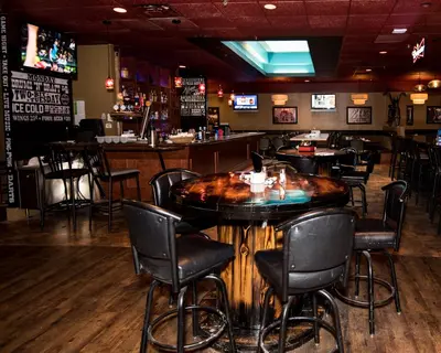 a bar with a wooden table in a restaurant at Paradise Inn & Conference Centre in Grande Prairie