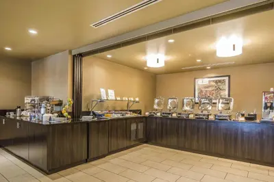 a restaurant with a counter in a room at Quality Hotel & Conference Centre in Fort McMurray
