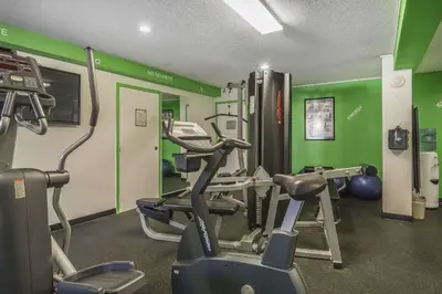 a gym with treadmills and exercise bikes in a room at Quality Hotel & Conference Centre in Fort McMurray