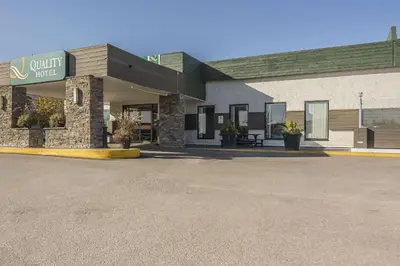 a empty parking lot in front of a building at Quality Hotel & Conference Centre in Fort McMurray