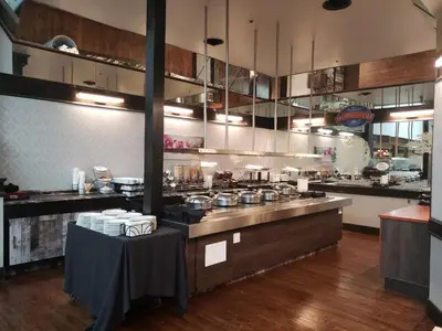 a kitchen with a counter with pots and pans at Baymont by Wyndham Red Deer in Red Deer