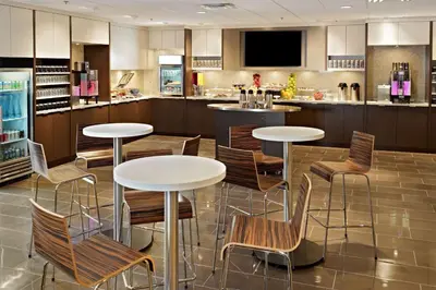 a restaurant with tables and chairs and a bar at Wyndham Edmonton Hotel and Conference Centre in Edmonton