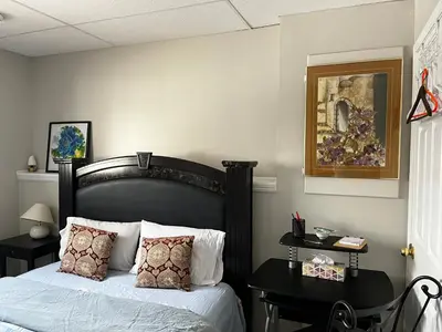 a bedroom with a bed with a black headboard at Citadel hill cr community! in Calgary