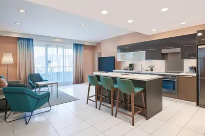 a kitchen with a island and chairs in a room at Residence Inn by Marriott Vancouver Downtown in Vancouver