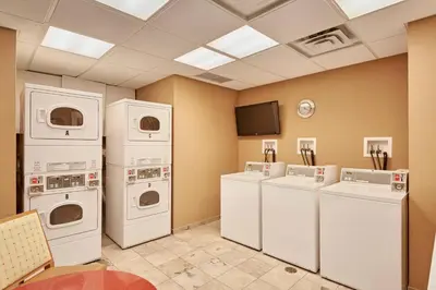 a laundry room with white appliances and a tv at Residence Inn by Marriott Vancouver Downtown in Vancouver