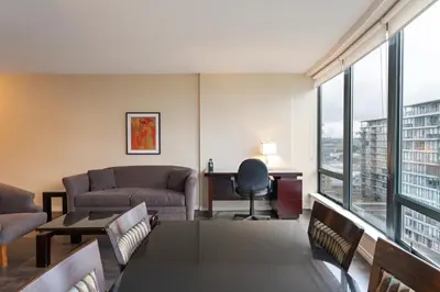 a living room with a couch and a table at Executive Hotel Vancouver Airport in Richmond